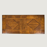 A rectangular table with hardwood parquetry top on bobbin-turned side supports and curved iron stretchers. Iberian probably 19th century.
