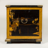 An 18th or 19th century Japanese lacquer coffer made from earlier lacquer panels, with engraved brass mounts.