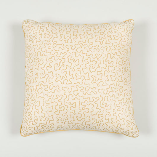 A 16” cushion in Squiggle Silhouette caramel finished with contrasted piping.