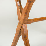 A provincial elm occasional table, late 19th/early 20th century, on x-frame supports.