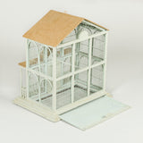 A painted wooden birdcage in the form of a gabled pavilion, 20th century.