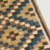 A Veramin kelim rug with a geometric pattern in blue, brown, black and mustard colours. Persian, 19th/20th century.