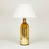 A large gold-lustre bottle-shaped glass vase converted to a lamp.