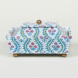 A fine cartonnage decorative trinket box covered in a small scale design patterned paper based on an original Regency tea caddy.