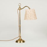 Late 19th, early 20th century brass desk lamp with round base and adjustable serpentine arm and card shade.