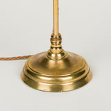 Late 19th, early 20th century brass desk lamp with round base and adjustable serpentine arm and card shade.