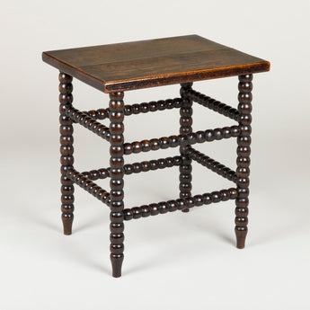 A small 19th century bobbin-turned stool or table, the top probably later than the base.
