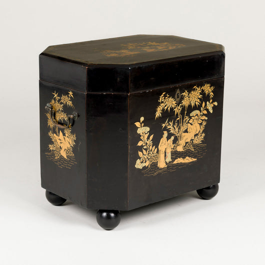 A small Chinese lacquer box decorated in gilt with Chinoiserie scenes, 19th century, on later ball feet.