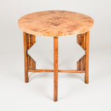 A round bamboo table with a veneered top and folding base. 20th century.