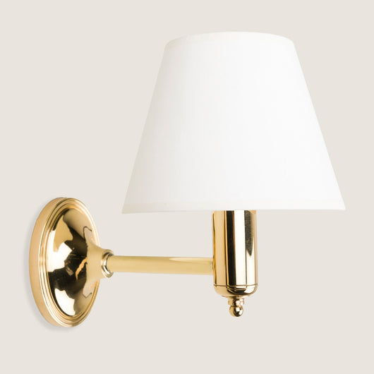 Fixed arm wall light with oval back plate. Lacquered Brass.