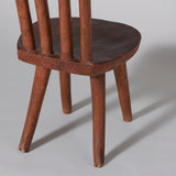 A rustic low side chair with a double hoop back and wooden seat, Madagascar, 20th century.