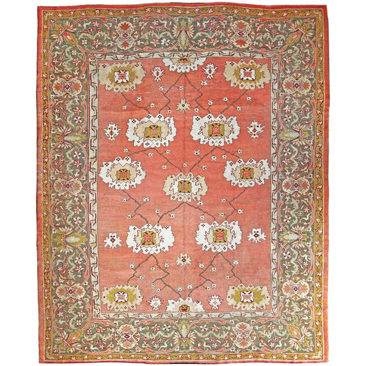 AN ANTIQUE USHAK CARPET CIRCA 1880 WITH AN OPEN FLORAL PALMETTE DESIGN ON A SOFT APRICOT GROUND.