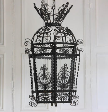 AN EARLY 20TH CENTURY HEXAGONAL SPANISH LANTERN IN FINE METAL SCROLL-WORK.