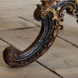 A 19TH CENTURY CHINESE EXPORT CENTRE TABLE WITH A LACQUERED AND DECORATED TILT TOP ON A CARVED AND GILDED BASE.