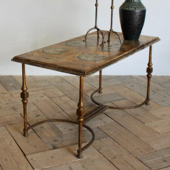 A 1960s/1970s SPANISH SIDE TABLE WITH A GILT METAL BASE AND LATER PAINTED DECORATION TO THE TOP.