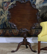 AN ENGLISH 18TH CENTURY GEORGE III TRIPOD TABLE WITH A PIE CRUST TOP WITH SCALLOP SHAPED DETAILS AND TRIFORM BASE.