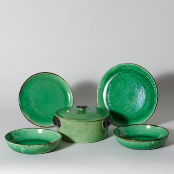 A collection of green glazed French pottery 13 bowls, 9 plates and a tureen. Dieulefit 20th C. some restored.