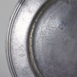 A large round pewter platter, probably 19th century.