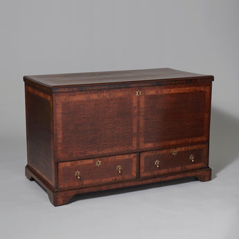 A 19th century oak coffer with two drawers to the base and cross-banding to the top, front and sides.
