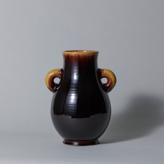 An Accolay pottery pot-bellied two-handled vase with treacle-brown and yellow glaze. French, mid-20th century.