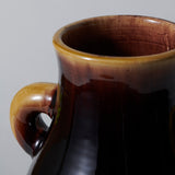 An Accolay pottery pot-bellied two-handled vase with treacle-brown and yellow glaze. French, mid-20th century.