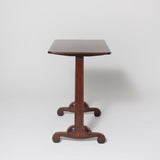 Simple rectangular early 19th century ash wood writing table, the end supports with elegant scrolled feet.