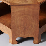 A low octagonal two-tier oak veneered table, early to mid 20th century.