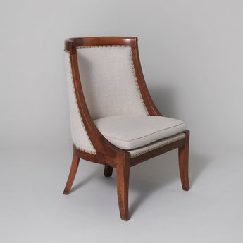 A pair of fruit-wood framed tub chairs with sabre legs, French circa 1810.