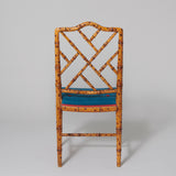 A pair of faux bamboo decorated side chairs with arched lattice backs, probably mid-20th century.
