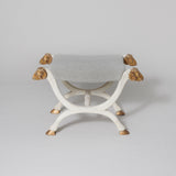 A white-painted & gilt X-frame stool with ram’s head finials and hoof feet. Probably 19th century.