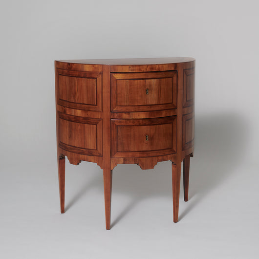 A pair of small late 18th century Italian fruitwood demi-lune commodes with two drawers on tapering legs.