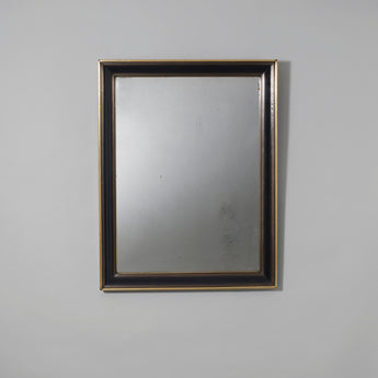 A rectangular mirror with a brass edged and inlaid mahogany frame and old mercury glass. French, c.1830.
