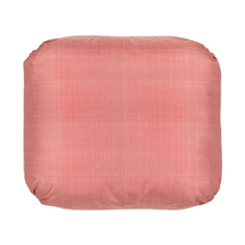 A CUSHION MADE UP IN AN APRICOT SILK AND CONTRAST PIPED.