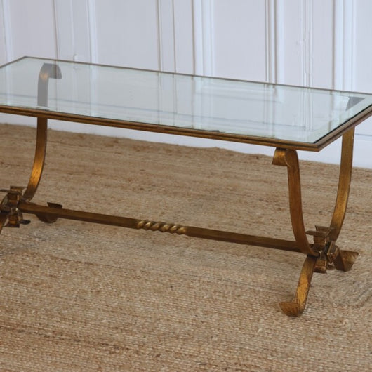 A 1940'S FRENCH GILDED IRON COFFEE TABLE WITH A GLASS TOP WITH MIRRORED BORDER IN THE STYLE OF GILBERT POILLERAT.