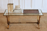 A 1940'S FRENCH GILDED IRON COFFEE TABLE WITH A GLASS TOP WITH MIRRORED BORDER IN THE STYLE OF GILBERT POILLERAT.