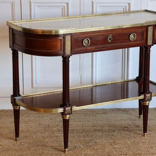 AN EARLY 20TH CENTURY FRENCH MAHOGANY CONSOLE DESSERT IN THE LOUIS XVI TASTE, RETAINING THE ORIGINAL MARBLE TOP AND GILT BRONZE MOUNTS.