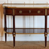 AN EARLY 20TH CENTURY FRENCH MAHOGANY CONSOLE DESSERT IN THE LOUIS XVI TASTE, RETAINING THE ORIGINAL MARBLE TOP AND GILT BRONZE MOUNTS.