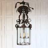 AN EARLY 20TH CENTURY ITALIAN PATINATED TOLE LANTERN OF LARGE SCALE, REWIRED.