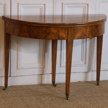 AN LATE 18TH CENTURY ENGLISH DEMI-LUNE FRUITWOOD TABLE WITH LOVELY COLOUR AND ORIGINAL BRASS CASTORS, OPENS UP TO MAKE A BREAKFAST TABLE.