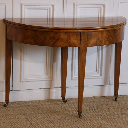 AN LATE 18TH CENTURY ENGLISH DEMI-LUNE FRUITWOOD TABLE WITH LOVELY COLOUR AND ORIGINAL BRASS CASTORS, OPENS UP TO MAKE A BREAKFAST TABLE.