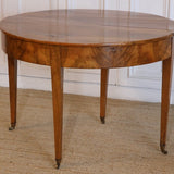 AN LATE 18TH CENTURY ENGLISH DEMI-LUNE FRUITWOOD TABLE WITH LOVELY COLOUR AND ORIGINAL BRASS CASTORS, OPENS UP TO MAKE A BREAKFAST TABLE.