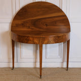 AN LATE 18TH CENTURY ENGLISH DEMI-LUNE FRUITWOOD TABLE WITH LOVELY COLOUR AND ORIGINAL BRASS CASTORS, OPENS UP TO MAKE A BREAKFAST TABLE.