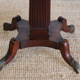 A LATE 18TH/EARLY 19TH CENTURY ENGLISH OCTAGONAL DRUM TABLE WITH LEATHER TOP  SET ON A REEDED COLUMN AND FOUR SPLAYED LEGS.