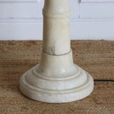 A MID-20TH CENTURY SPANISH SOLID ALBASTER STANDARD LAMP MADE UP OF TURNED AND POLISHED SECTIONS ON A TURNED ROUND BASE.
