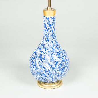 A pair of late 19th century spiral-fluted pot-bellied vases with blue and white floral decoration, wired as lamps. .