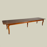 An exceptionally long 19th century French fruit wood farmhouse table with a plank top and lovely colour.