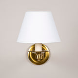 An articulated brass wall light with round back plate. Late 20th century, rewired.