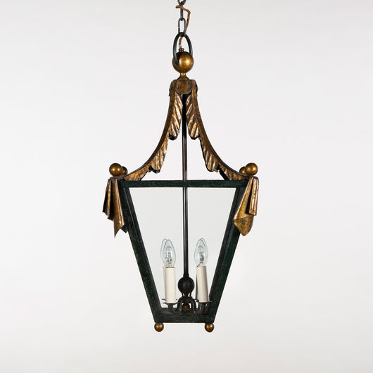 A mid-century French gilt iron lantern of tapered squared shape, the upper structure in the form of swags of fabric. Possibly by Poillerat, circa 1950.