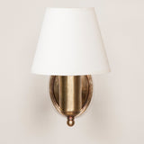 Fixed arm wall light with oval back plate. Antiqued Brass.