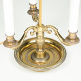 A 19th century brass bouillotte lamp with green painted tole shade.